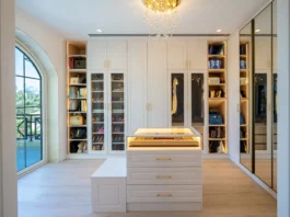 Luxury home renovation in Dubai featuring an elegant walk-in closet with custom cabinetry and a chandelier.